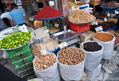 Image of spices and nuts on the scales and dishes in an old bazaar