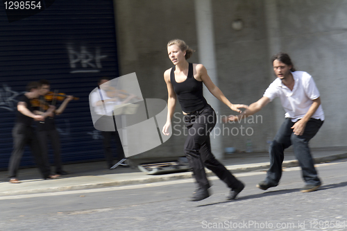 Image of Dancers running in the street