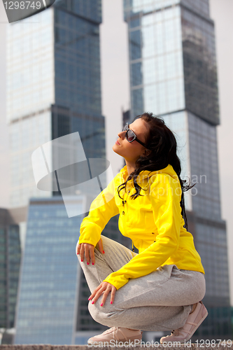 Image of brunette in a yellow blazer