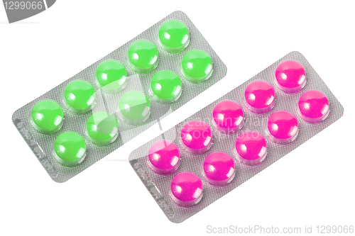 Image of Two metallic blister with purple and green pills