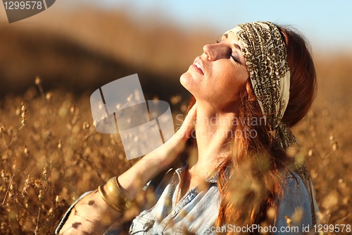 Image of Beautiful Woman on a Field in Summertime 