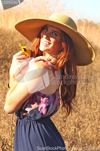 Image of Young Beautiful Woman on a Field in Summer Time