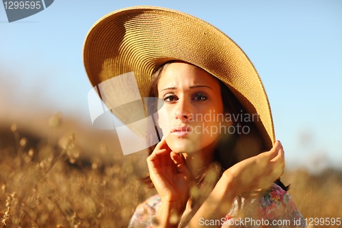 Image of Young Beautiful Woman on a Field in Summer Time