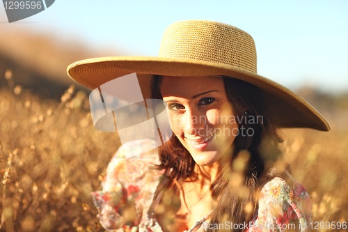 Image of Young Beautiful Woman on a Field in Summer Time