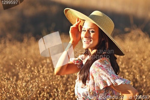 Image of Young Beautiful Woman on a Field in Summer Time
