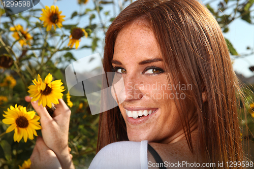 Image of Red Haired Woman Outdoors in a Sunflower Field
