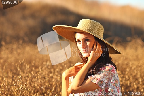 Image of Young Beautiful Woman on a Field in Summer Time