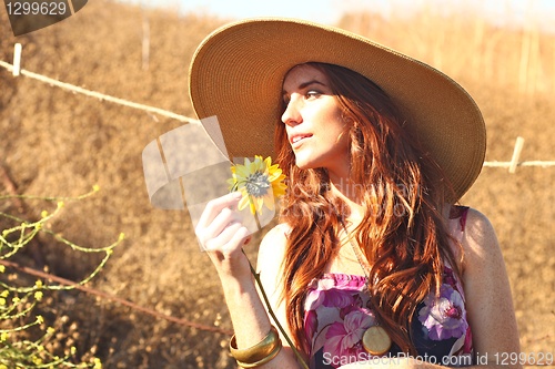 Image of Young Beautiful Woman on a Field in Summer Time