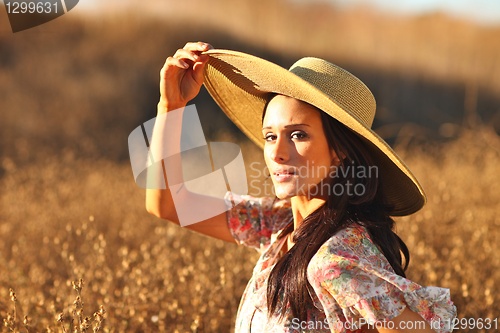 Image of Young Beautiful Woman on a Field in Summer Time