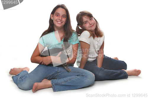 Image of Two Sisters Holding Their Young Kitten