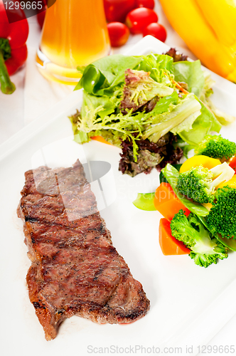 Image of juicy BBQ grilled rib eye ,ribeye steak and vegetables