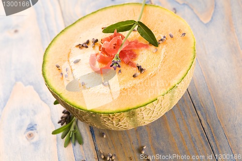 Image of fresh melon soup with parma ham and lavender flower