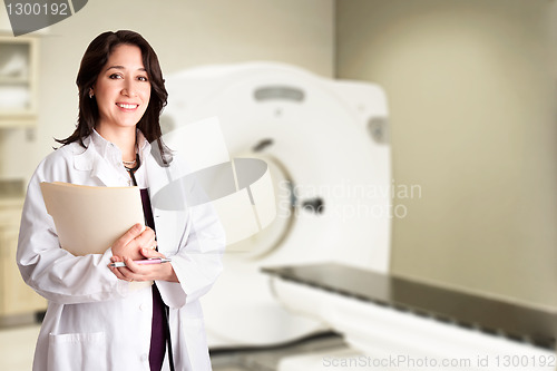 Image of Female doctor radiologist at CT CAT scan with chart