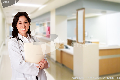 Image of Happy Doctor with patient chart file dossier in hospital