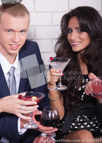 Image of Couple on date in bar or night club enjoying wine