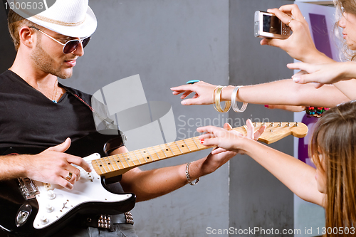 Image of Selective focus on guitarist in action