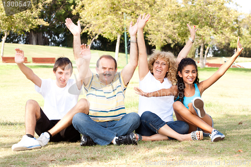 Image of Young family having fun in park