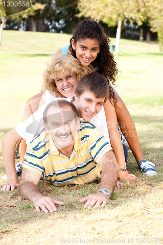 Image of Family lying on top of each other