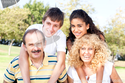 Image of Parents giving kids piggy back ride