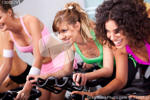 Image of Females cycling in spinning class in gym