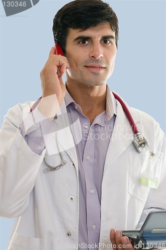 Image of Male medical professional at work using wireless technologies