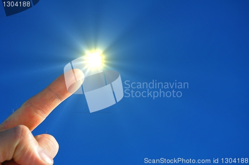 Image of hand sun and blue sky