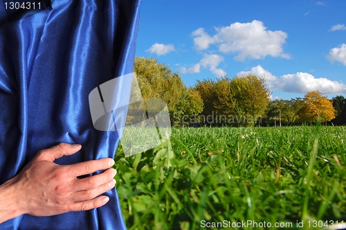 Image of landscape behind blue curtain