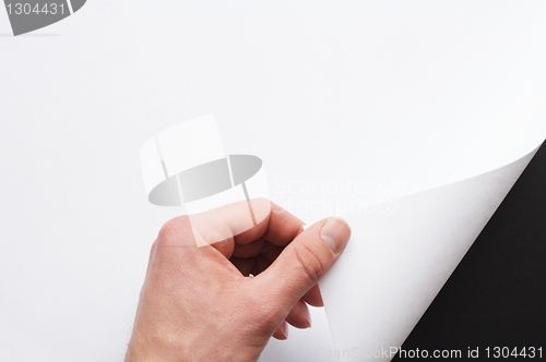 Image of hand turning paper