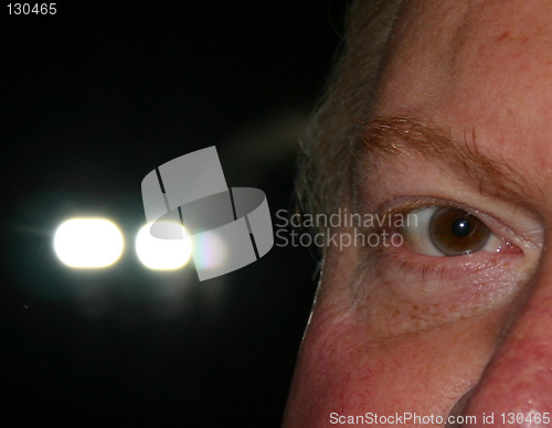 Image of eye with lights in the background