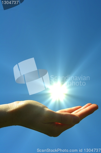 Image of hand sun and blue sky