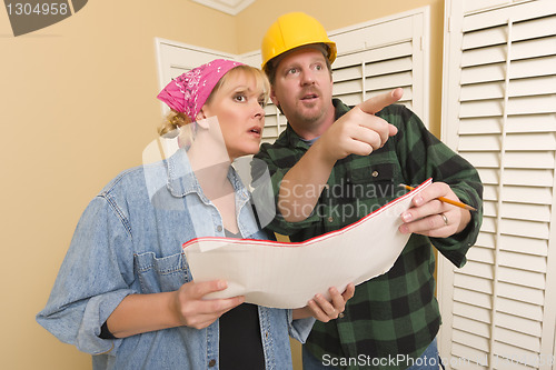 Image of Contractor in Hard Hat Discussing Plans with Woman