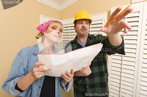 Image of Contractor in Hard Hat Discussing Plans with Woman