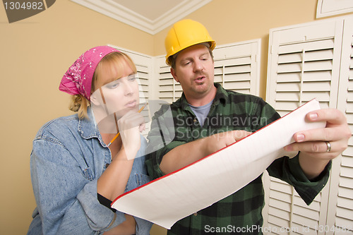 Image of Contractor in Hard Hat Discussing Plans with Woman