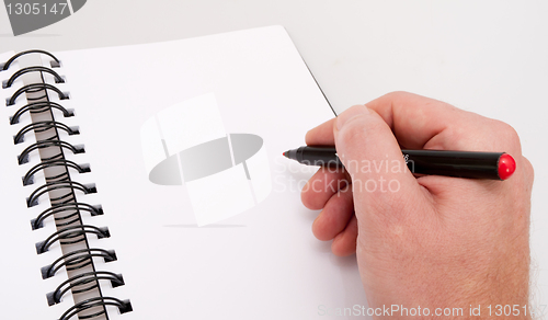 Image of Open Notebook and Hand With Marker