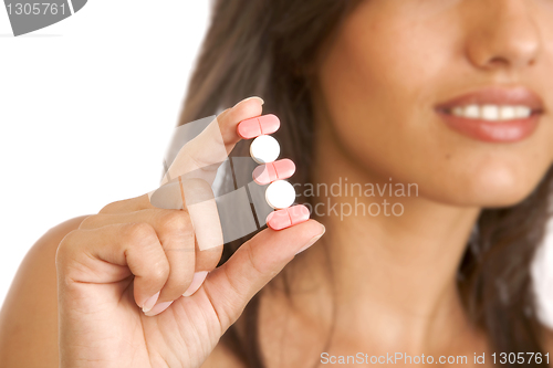 Image of young woman with pills