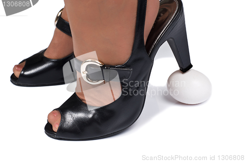 Image of High heels over egg