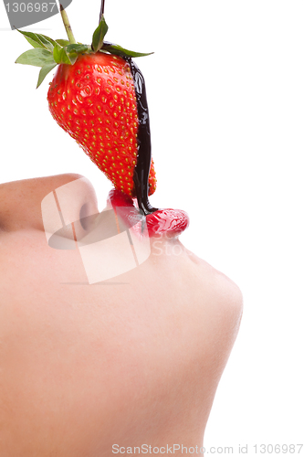 Image of girl eating strawberry with chocolate sauc