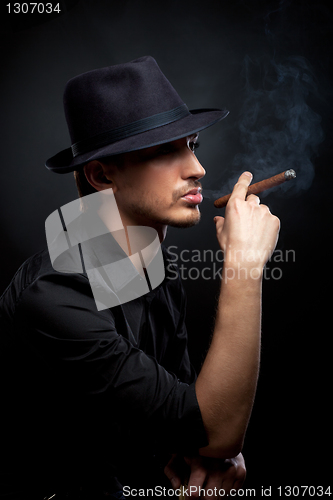 Image of Gangster look. Man with hat and cigar.