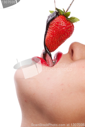 Image of girl eating strawberry with chocolate sauc