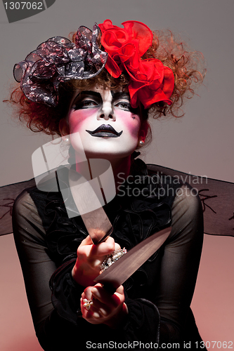 Image of woman mime with knife