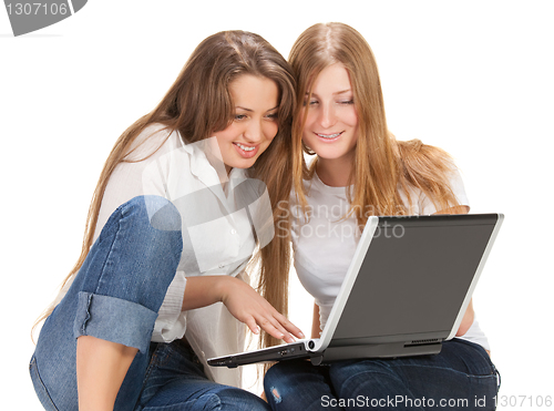 Image of two young happy student girl work on laptop