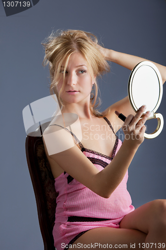 Image of beautiful woman with mirror
