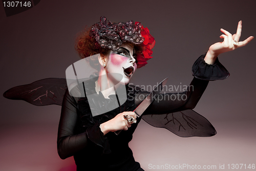 Image of woman mime with knife