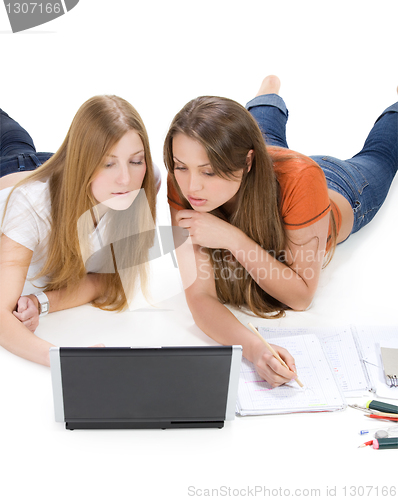 Image of two young happy student girl work on laptop