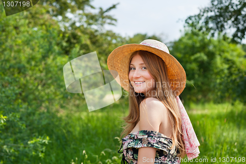 Image of Young beautiful girl with hat posing outdoor