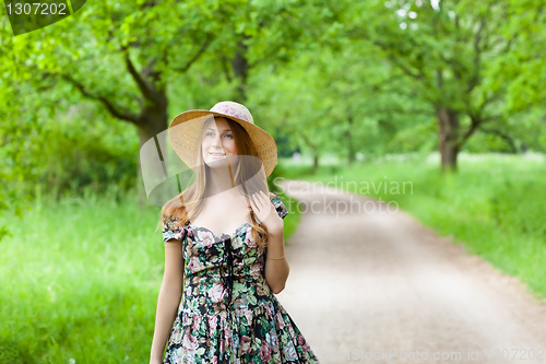 Image of Young beautiful girl with hat posing outdoor