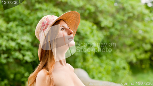 Image of Young beautiful girl with hat posing outdoor