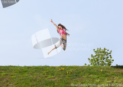 Image of Happy young woman jumping