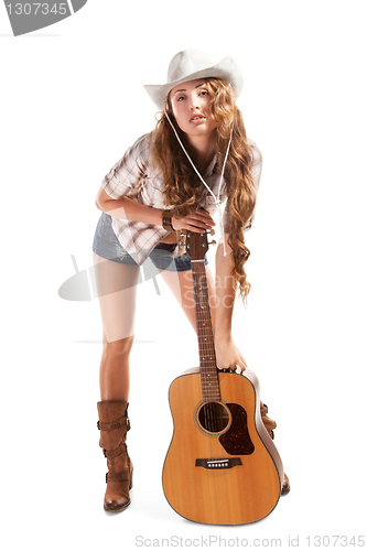 Image of Sesy cowgirl in cowboy hat with acoustic guitar