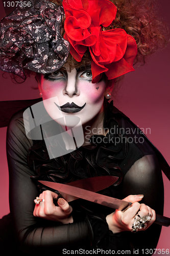 Image of woman mime with knife